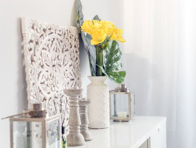 wood candlesticks and a lantern decorating a shelf